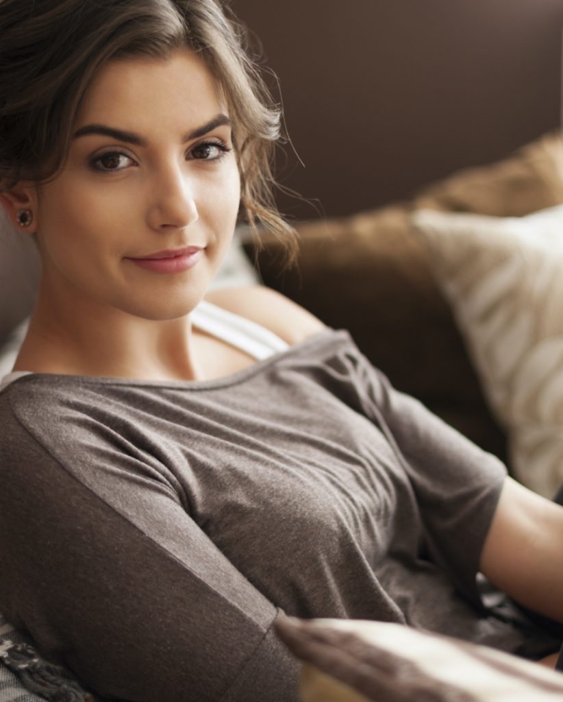 Brunette woman sitting on a couch