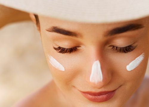 Woman at the beach with sunscreen on her face