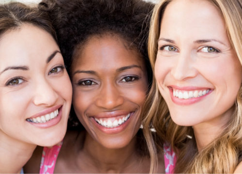 Three happy female friends with great skin